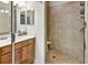 Bathroom featuring a glass enclosed walk-in shower with neutral colored tile and a single sink vanity at 7305 River Hammock Dr # 204, Bradenton, FL 34212