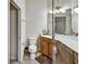 Bright bathroom with a vanity, commode, and tiled floor, offering a blend of comfort and functionality at 7305 River Hammock Dr # 204, Bradenton, FL 34212