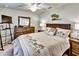 Cozy bedroom with ceiling fan, dresser, TV and decorative accents creating a relaxing space at 7305 River Hammock Dr # 204, Bradenton, FL 34212