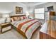 Bright bedroom with a large bed, stylish decor, and a dresser creating a cozy and inviting space at 7305 River Hammock Dr # 204, Bradenton, FL 34212