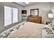 Bedroom featuring a ceiling fan and large window allowing ample natural light creating a calming ambiance at 7305 River Hammock Dr # 204, Bradenton, FL 34212