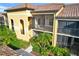 Lovely condominium featuring a terra cotta tile roof, screened balconies, and lush landscaping at 7305 River Hammock Dr # 204, Bradenton, FL 34212