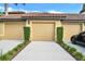 Attached three-car garage with well-manicured landscaping enhancing curb appeal at 7305 River Hammock Dr # 204, Bradenton, FL 34212