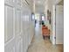 Well-lit hallway featuring decorative molding, tile floors and stylish decor at 7305 River Hammock Dr # 204, Bradenton, FL 34212