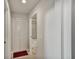 Hallway leading to a bathroom with tub, featuring tile floors and an enclosed closet at 7305 River Hammock Dr # 204, Bradenton, FL 34212
