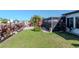 Well-maintained backyard with a view of the canal, lawn, and tropical foliage surrounding the home at 7309 Islander Ln, Hudson, FL 34667