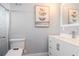 Modern bathroom features a toilet, vanity, and tiled shower area at 7309 Islander Ln, Hudson, FL 34667