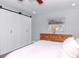 Bedroom featuring a spacious closet with sliding barn doors and ample natural light at 7309 Islander Ln, Hudson, FL 34667