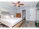 Comfortable bedroom with stylish wood-look floors, ceiling fan and modern furniture at 7309 Islander Ln, Hudson, FL 34667