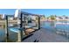 Waterfront living with a private boat lift for easy water access and boating adventures from your backyard at 7309 Islander Ln, Hudson, FL 34667