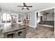 Inviting dining room with wood-look tile flooring, ceiling fan, and ample natural light at 7309 Islander Ln, Hudson, FL 34667