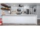 Well-lit kitchen with white cabinetry, stainless steel appliances, and a sleek countertop at 7309 Islander Ln, Hudson, FL 34667