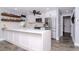 Modern kitchen features white cabinetry, stainless steel appliances, and a quartz countertop island at 7309 Islander Ln, Hudson, FL 34667