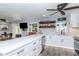 Modern kitchen with sleek countertops, white cabinetry, stainless steel appliances, and eat in bar at 7309 Islander Ln, Hudson, FL 34667