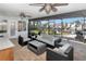Relaxing covered lanai with comfortable seating, ceiling fans, and views of the manicured backyard at 7309 Islander Ln, Hudson, FL 34667