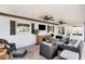 Outdoor living at its finest: a spacious, screened lanai complete with a built-in kitchen and cozy seating at 7309 Islander Ln, Hudson, FL 34667