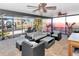 Covered lanai featuring stylish outdoor furniture, ceiling fans, and relaxing waterfront views at 7309 Islander Ln, Hudson, FL 34667