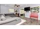 Inviting living room with a plush sectional, mounted TV, and a view into the sunroom at 7309 Islander Ln, Hudson, FL 34667