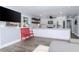 Cozy living space with wood floors, a modern kitchen, and comfortable seating at 7309 Islander Ln, Hudson, FL 34667