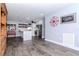 Spacious living area featuring wood floors, a modern kitchen, and stylish decor at 7309 Islander Ln, Hudson, FL 34667