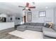 Comfortable living room area featuring eat in bar, gray sectional, and view into kitchen at 7309 Islander Ln, Hudson, FL 34667