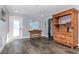 Bright living room boasts wood-look floors, white door and trim, and wooden shelves at 7309 Islander Ln, Hudson, FL 34667