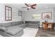 Comfortable living room with a large sectional sofa, wood floors, and decorative accents at 7309 Islander Ln, Hudson, FL 34667