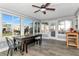 Inviting sun room featuring ceiling fan, tile floors, and multiple windows for scenic views at 7309 Islander Ln, Hudson, FL 34667