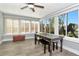 Sunny sunroom with large windows providing ample natural light and views of the lush surroundings at 7309 Islander Ln, Hudson, FL 34667