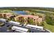 Aerial view of an apartment complex featuring well-kept landscaping, adjacent to golf course and ponds at 8403 Grand Estuary Trl # 204, Bradenton, FL 34212