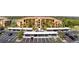 View of a residential building with covered parking and well maintained grounds on a clear, sunny day at 8403 Grand Estuary Trl # 204, Bradenton, FL 34212