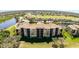 Aerial shot of an apartment building surrounded by a lush green golf course and scenic waterways at 8403 Grand Estuary Trl # 204, Bradenton, FL 34212