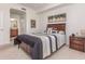 Bedroom with carpeted floors, stylish decor, and access to an ensuite bathroom for convenience at 8403 Grand Estuary Trl # 204, Bradenton, FL 34212