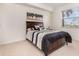Cozy bedroom features neutral decor, a large window, and an inviting upholstered headboard bed at 8403 Grand Estuary Trl # 204, Bradenton, FL 34212