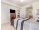 Comfortable carpeted bedroom with a large window and a ceiling fan at 8403 Grand Estuary Trl # 204, Bradenton, FL 34212