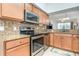 Contemporary kitchen with stainless appliances, sleek cabinetry, and granite countertops at 8403 Grand Estuary Trl # 204, Bradenton, FL 34212