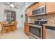 Charming eat-in kitchen featuring stainless steel appliances and a cozy dining area at 8403 Grand Estuary Trl # 204, Bradenton, FL 34212