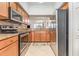 Modern kitchen with stainless steel appliances, granite countertops, and ample cabinet space at 8403 Grand Estuary Trl # 204, Bradenton, FL 34212