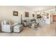 Comfortable seating, tile floors, and a view of the kitchen bar area enhance this living room at 8403 Grand Estuary Trl # 204, Bradenton, FL 34212