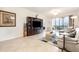 Cozy living room with a built-in entertainment center and sliding glass doors leading to the lanai at 8403 Grand Estuary Trl # 204, Bradenton, FL 34212
