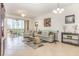 Bright living room with tile floors, neutral tones, comfortable seating, and a screened lanai at 8403 Grand Estuary Trl # 204, Bradenton, FL 34212