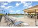 View of the pool with lounge chairs and outdoor eating space at 8403 Grand Estuary Trl # 204, Bradenton, FL 34212