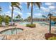Stunning community pool and spa area surrounded by lush landscaping, and comfortable lounge seating at 8403 Grand Estuary Trl # 204, Bradenton, FL 34212