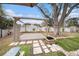 Relaxing backyard featuring a custom deck area, mature tree, and lush lawn at 908 Woodley Rd, Clearwater, FL 33764