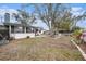 Expansive backyard offers a custom patio, mature tree, and ample space for outdoor enjoyment at 908 Woodley Rd, Clearwater, FL 33764