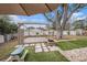 Outdoor oasis with a wooden pergola, lush lawn, and a built-in fire pit perfect for entertaining and relaxing at 908 Woodley Rd, Clearwater, FL 33764