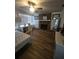Bright bedroom with hardwood floors, ceiling fan, brick fireplace, and lots of natural light at 908 Woodley Rd, Clearwater, FL 33764