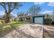 A nicely landscaped driveway with a home that has a covered porch with chairs for relaxing at 908 Woodley Rd, Clearwater, FL 33764