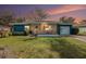 Charming single-story home showcasing a quaint porch, lush lawn, and appealing curb appeal at 908 Woodley Rd, Clearwater, FL 33764