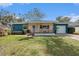 Inviting home boasting a covered porch, well-manicured lawn, and a one-car garage at 908 Woodley Rd, Clearwater, FL 33764